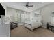 Bright bedroom boasts a ceiling fan, large windows, and a comfy armchair at 20718 W Colter St, Buckeye, AZ 85396