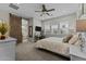 This bedroom has a ceiling fan and offers a peek at the ensuite bathroom at 20718 W Colter St, Buckeye, AZ 85396