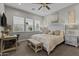 This bedroom offers a desk, ceiling fan, and large windows at 20718 W Colter St, Buckeye, AZ 85396