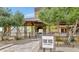 Attractive entrance to community featuring 'The Vic' bar and kitchen surrounded by trees at 20718 W Colter St, Buckeye, AZ 85396