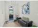 Stylish entryway with a black leather bench, modern art, and hardwood floors at 20718 W Colter St, Buckeye, AZ 85396