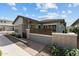 Charming single-story home featuring a well-maintained front yard and modern architectural design elements at 20718 W Colter St, Buckeye, AZ 85396
