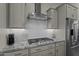 Modern kitchen features granite countertops, stainless steel appliances, and gray cabinets at 20718 W Colter St, Buckeye, AZ 85396