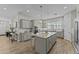 Spacious kitchen featuring a large island with granite countertops and modern lighting at 20718 W Colter St, Buckeye, AZ 85396