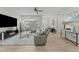 Spacious living room with a modern fireplace, TV, and comfortable gray sectional sofa at 20718 W Colter St, Buckeye, AZ 85396