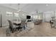 Open-concept living space with a modern dining table and comfortable seating area at 20718 W Colter St, Buckeye, AZ 85396