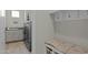 This mud room features a bench, coat hooks, and laundry machines at 20718 W Colter St, Buckeye, AZ 85396