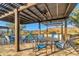 Inviting outdoor dining area with a pergola, barbecue, and stunning mountain views in a community space at 20718 W Colter St, Buckeye, AZ 85396