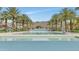 Beautiful community pool with lounge chairs and palm trees with mountain views at 20718 W Colter St, Buckeye, AZ 85396