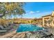 Beautiful community pool with lounge chairs, set against a backdrop of mountains and clear skies at 20718 W Colter St, Buckeye, AZ 85396