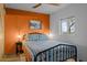 Comfortable bedroom with vibrant orange accent wall, cozy bedding, and natural light at 2125 Us Highway 93 --, Wickenburg, AZ 85390