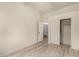 This bedroom includes a closet with sliding doors, wood-look floors, and an open door to another room at 2164 W Megan St, Chandler, AZ 85224
