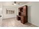 Bedroom with tile floors, built-in shelving and desk, a ceiling fan, and natural light at 2164 W Megan St, Chandler, AZ 85224