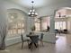 Bright dining room with elegant light fixture and a charming window with shutters at 2164 W Megan St, Chandler, AZ 85224