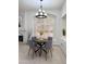 Charming dining room with modern lighting fixture and natural light from large windows at 2164 W Megan St, Chandler, AZ 85224