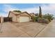 View of the front exterior showing the garage and driveway with neatly trimmed bushes in front of the house at 2164 W Megan St, Chandler, AZ 85224