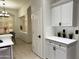 Bright, modern kitchen featuring white cabinetry, marble countertops, and an open layout to the dining area at 2164 W Megan St, Chandler, AZ 85224