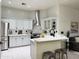 Modern kitchen featuring white cabinets, stainless steel appliances, and a breakfast bar for casual dining at 2164 W Megan St, Chandler, AZ 85224