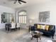 Cozy living room with comfortable seating and dining area bathed in natural light from the large window at 2164 W Megan St, Chandler, AZ 85224
