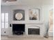 Cozy living room featuring a fireplace, built-in shelving, and modern decor at 2164 W Megan St, Chandler, AZ 85224