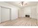 Spacious living room with light wood flooring, fireplace, and access to other rooms at 2164 W Megan St, Chandler, AZ 85224