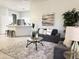Inviting living room featuring a modern sofa set, stylish rug, and seamless flow into the kitchen area at 2164 W Megan St, Chandler, AZ 85224