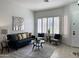 Bright living room with a blue sofa, decorative pillows, and plantation shutters at 2164 W Megan St, Chandler, AZ 85224