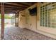 Outdoor living space with brick flooring, ceiling fan, and TV at 2164 W Megan St, Chandler, AZ 85224