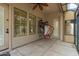 This covered patio area has a window and a door leading to the yard and pool at 2164 W Megan St, Chandler, AZ 85224