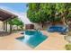 Backyard pool with lush landscaping, storage shed, and outdoor seating at 2164 W Megan St, Chandler, AZ 85224