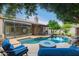 Relaxing backyard pool and spa area with a water feature, surrounded by mature trees and comfortable seating at 2164 W Megan St, Chandler, AZ 85224