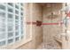 Beautiful shower with glass block window, tiled walls and floors, and a pebble floor at 2164 W Megan St, Chandler, AZ 85224