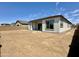 The spacious backyard of the property includes large windows that bring natural light, enhancing its appeal at 22685 E Saddle Way, Queen Creek, AZ 85142