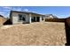 The backyard reveals ample space, surrounded by a brick wall, perfect for landscaping and outdoor enjoyment at 22685 E Saddle Way, Queen Creek, AZ 85142