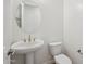 Powder room featuring a pedestal sink and toilet at 22685 E Saddle Way, Queen Creek, AZ 85142