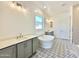 Stylish bathroom featuring a soaking tub, patterned floor tile, and gray cabinets with light countertops at 22685 E Saddle Way, Queen Creek, AZ 85142