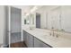 Bathroom with dual sinks, grey cabinets, and a large mirror at 22685 E Saddle Way, Queen Creek, AZ 85142