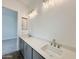 Modern bathroom with double sinks, gray cabinets, and stylish lighting fixtures at 22685 E Saddle Way, Queen Creek, AZ 85142