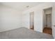 Spacious bedroom with neutral carpet, closet, and bright white walls at 22685 E Saddle Way, Queen Creek, AZ 85142