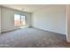 Bright bedroom featuring plush carpet, natural light, and serene views of the neighborhood at 22685 E Saddle Way, Queen Creek, AZ 85142