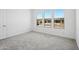 Bright bedroom with three sunny windows and neutral carpet at 22685 E Saddle Way, Queen Creek, AZ 85142