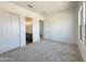 Neutral bedroom with large windows, closet, and easy access to the ensuite bathroom at 22685 E Saddle Way, Queen Creek, AZ 85142