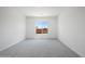 Well-lit, carpeted bedroom with a large window offers plenty of natural light at 22685 E Saddle Way, Queen Creek, AZ 85142