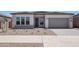 Charming single-story home with a neutral color palette, low-maintenance landscaping, and a two-car garage at 22685 E Saddle Way, Queen Creek, AZ 85142