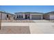 Welcoming single-story home with low-water landscaping, a neutral color scheme, and a convenient two-car garage at 22685 E Saddle Way, Queen Creek, AZ 85142