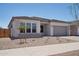 Attractive single-story home with desert landscaping, neutral colors, and a two-car garage at 22685 E Saddle Way, Queen Creek, AZ 85142