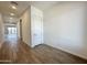 Bright hallway with wood-look tile flooring and recessed lighting leading to the main living areas at 22685 E Saddle Way, Queen Creek, AZ 85142