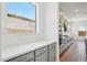 Well-appointed kitchen with gray cabinetry, white subway tile backsplash, and wood flooring at 22685 E Saddle Way, Queen Creek, AZ 85142