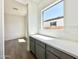 Convenient butler's pantry with gray cabinets, counter space, and natural light from the window at 22685 E Saddle Way, Queen Creek, AZ 85142