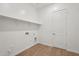 Bright laundry room with a shelf, hookups, and tile flooring at 22685 E Saddle Way, Queen Creek, AZ 85142